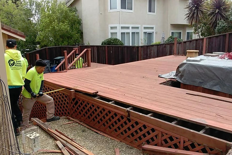 Junk removal expert performing deck demolition services