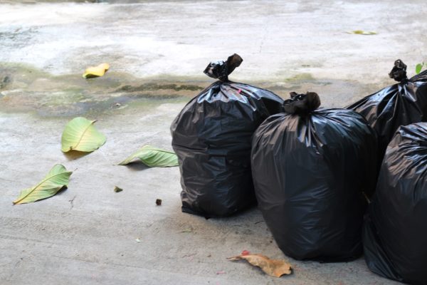 Bags of trash in need of trash removal services
