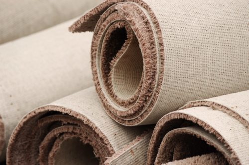Rolls of carpet to be removed by junk removal experts.