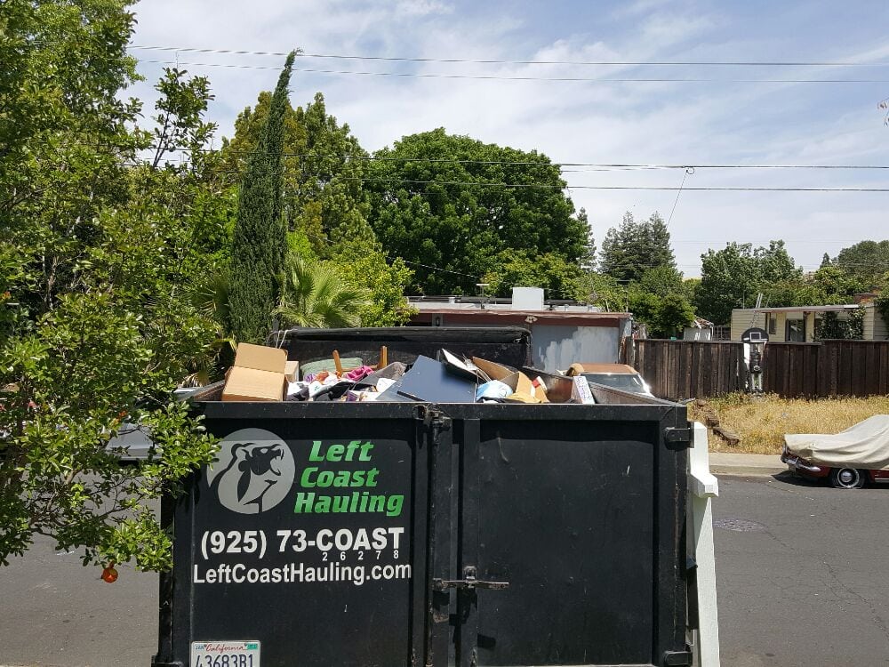 Left Coast Hauling truck filled with old furniture and more during junk removal services in Dublin, CA
