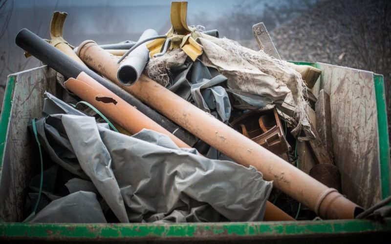 Construction trash removal truck filled with construction debris