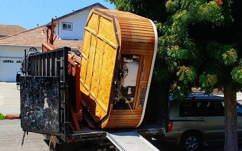 Hot tub removal being performed in the back of a truck